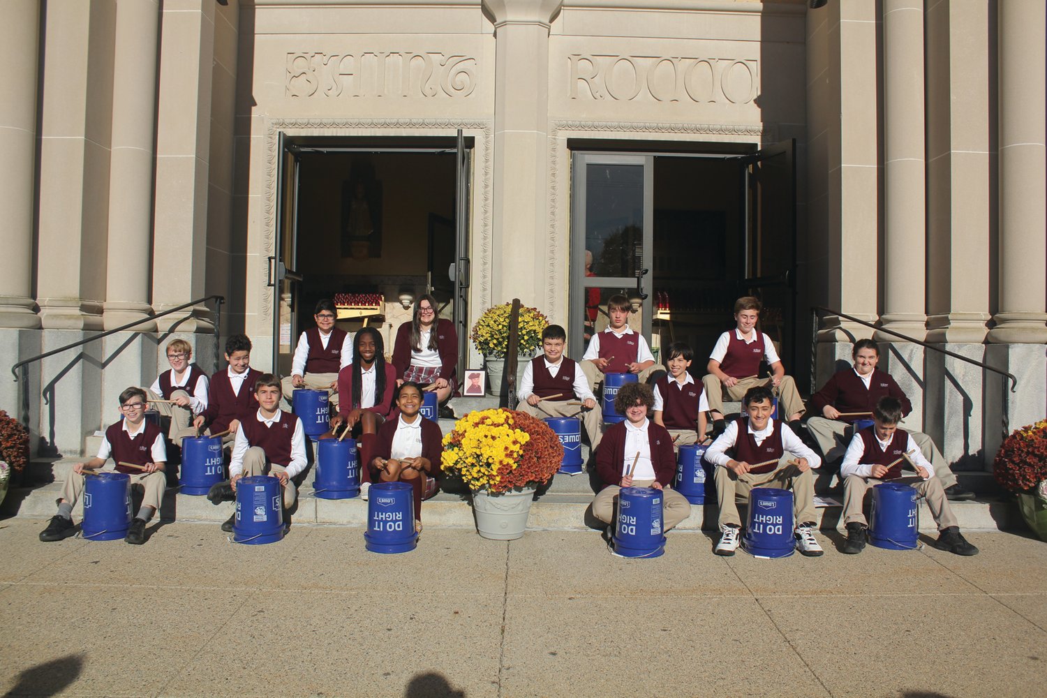 PATRIOTIC PRAYERS: Seventh grade students played "Stars & Stripes Forever" on drums as guests gathered outside St. Rocco School, which held its Veterans Day Prayer Service Wednesday, Nov. 9 at St. Rocco Church, 931 Atwood Ave., Johnston. Students from St. Rocco School read poems that they wrote, carried photos of loved ones, sang patriotic songs and prayed for all veterans.  Also, the school held a “Dress Down Day” for "Operation Christmas Stocking" where students dressed in red, white and blue, along with donating a dollar for the cause. Proceeds will go toward filling stockings for soldiers in the 43rd MP Brigade. (Photos courtesy Robin Okolowitcz of St. Rocco School)